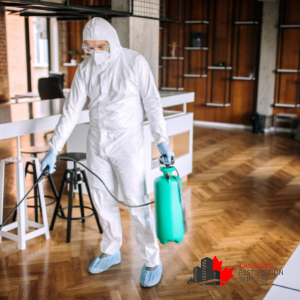 commercial cleaning company in hazmat suit disinfects office
